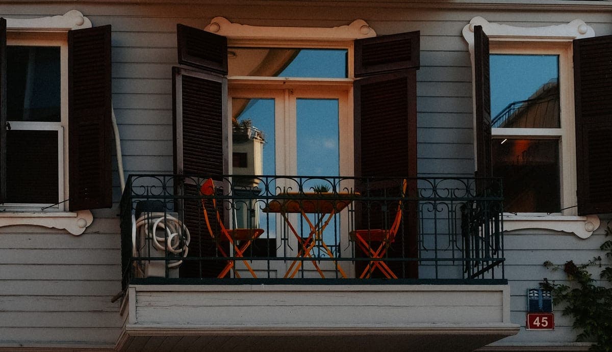 A compact balcony with a small table and chairs