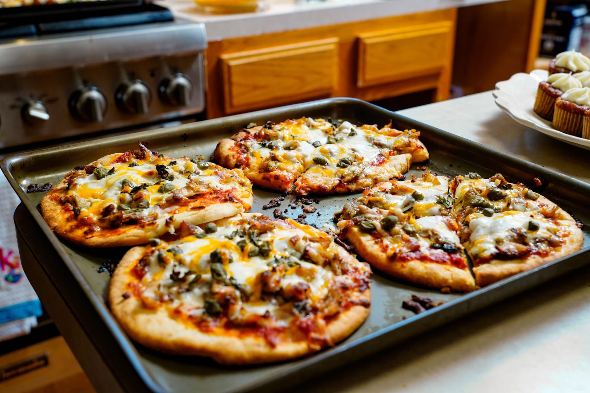 Freshly baked pizzas cooling on a kitchen counter